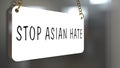 English texts Ã¢â¬ÅStop Asian HateÃ¢â¬Â on label in front of shop, concept for calling international community to stop hurting and